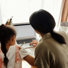 mother helping her daughter with homework 4260475
