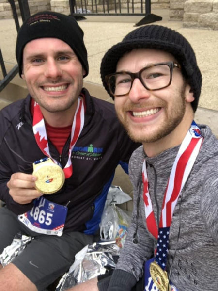 Matt and Casey holding medals after a marathon
