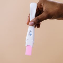 pregnancy stick dark skin hand